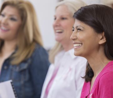 A group of women learning about the early signs of cancer