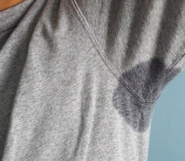 close up of someone in a grey t-shirt with sweaty underarms