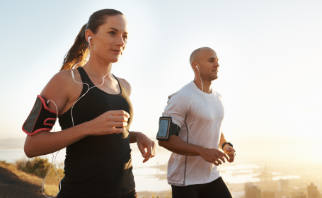 A man and woman listening to music while discovering the benefits of running