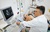 Male-doctor-examining-a-patients-heart-by-using-an-ultrasound-equipment