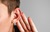 Man cupping ear to hear ahead of his Vibrant Soundbridge middle ear implant