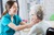 Nurse-uses-humour-while-palpating-senior-patients-neck