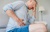 Man needing Crohn’s disease surgery holds stomach in pain